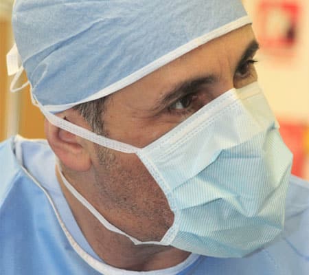 Dr Anthony Maloof a corneal and oculoplastic surgeon, dressed in surgical scrubs, face mask and hat. Ready for surgery.